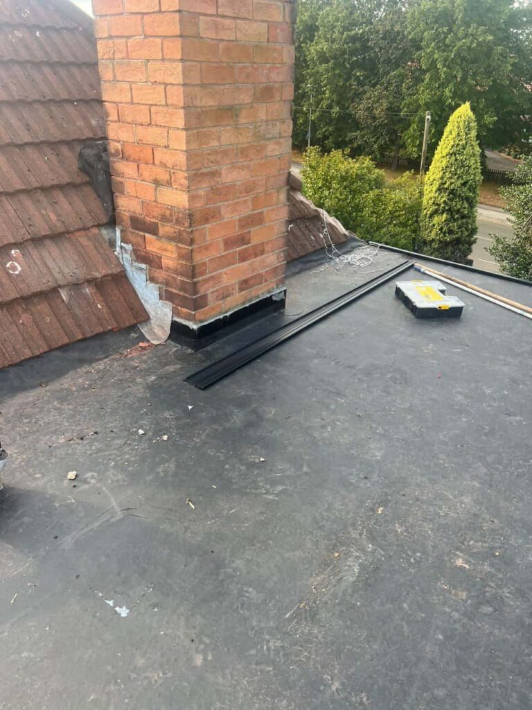 This is a photo of a flat roof which has just been repaired, there is also a chimney stack and some leadwork has also been dressed. Works carried out by Thetford Roofing Repairs